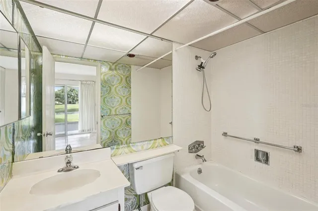 a bathroom with a sink mirror toilet and bathtub