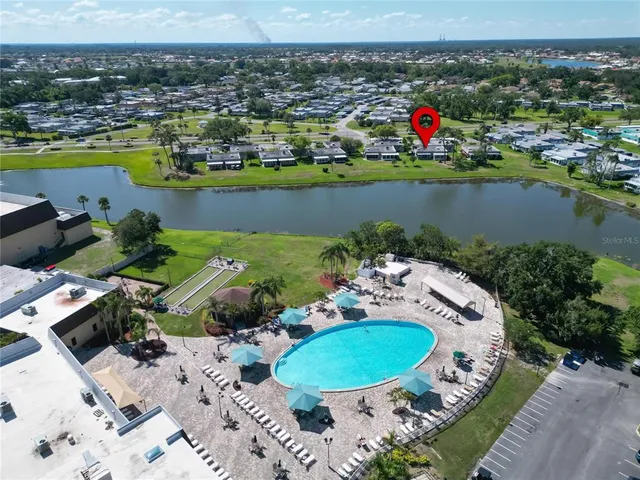 an aerial view of a city with lots of residential buildings lake and ocean view