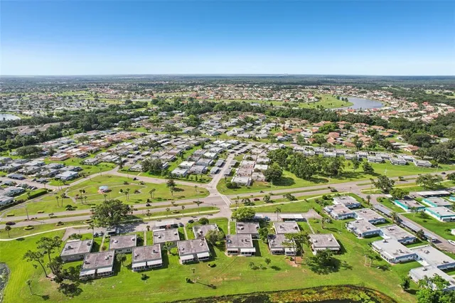 an aerial view of residential houses with outdoor space and swimming pool