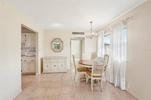 a view of a kitchen with a dining table and chairs
