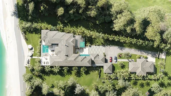 an aerial view of a house with outdoor space and a lake view