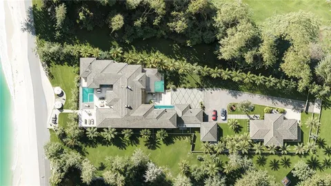 an aerial view of a house with outdoor space and a lake view