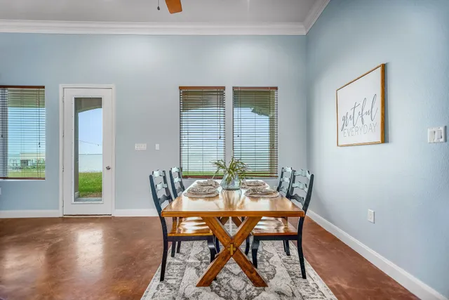 a view of a dining room with furniture a chandelier