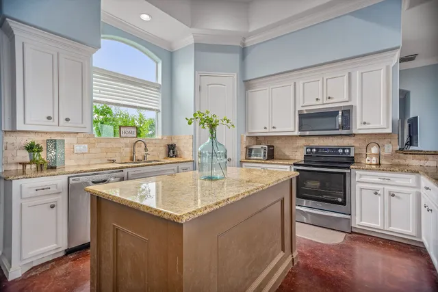 a kitchen with a stove a sink and a refrigerator
