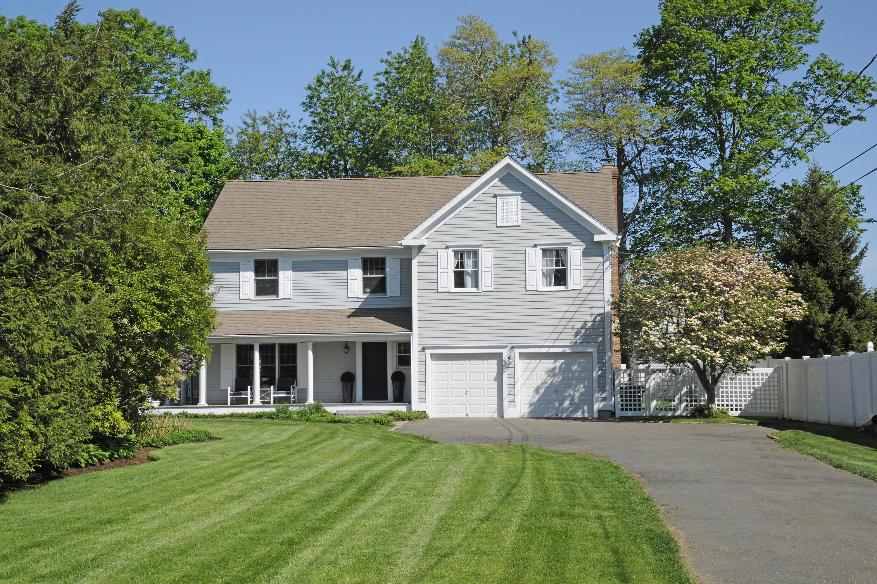 27 A Middlesex Road Darien, CT 06820 - Photo 2 of 27 a front view of a house with a yard and trees