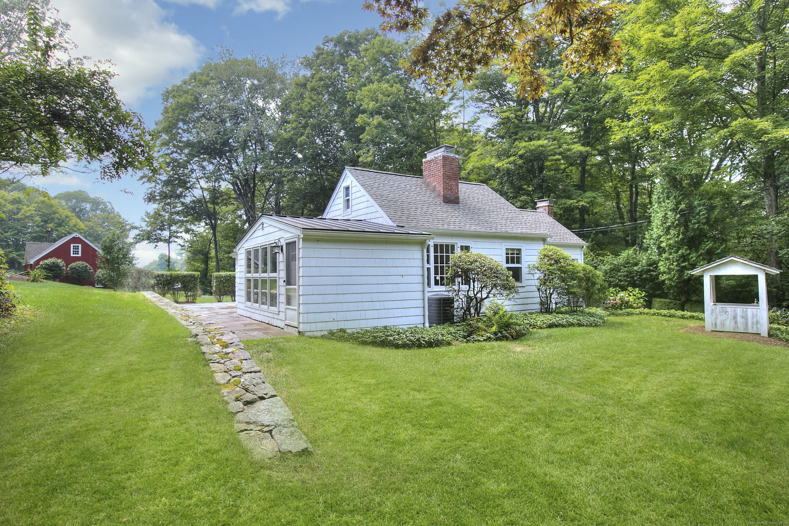 a front view of a house with a yard table and chairs