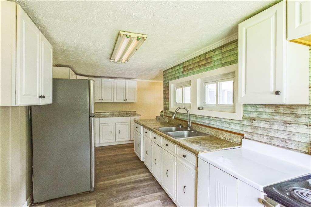 2523 Highway 411 Ranger, GA 30734 - Photo 5 of 9 a kitchen with a sink stove and refrigerator