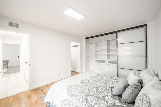 a bedroom with a large bed and a large window