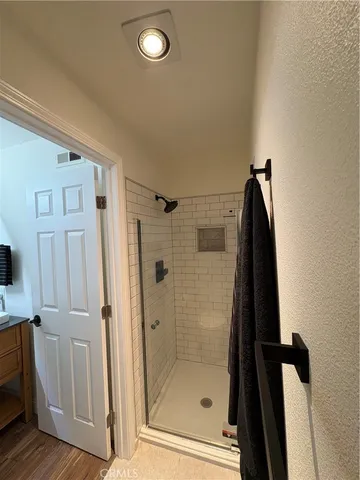 a bathroom with a shower and a sink