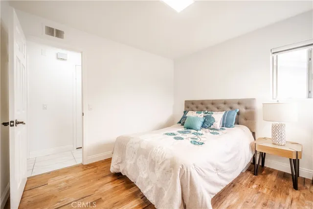 a bedroom with a bed and a night stand