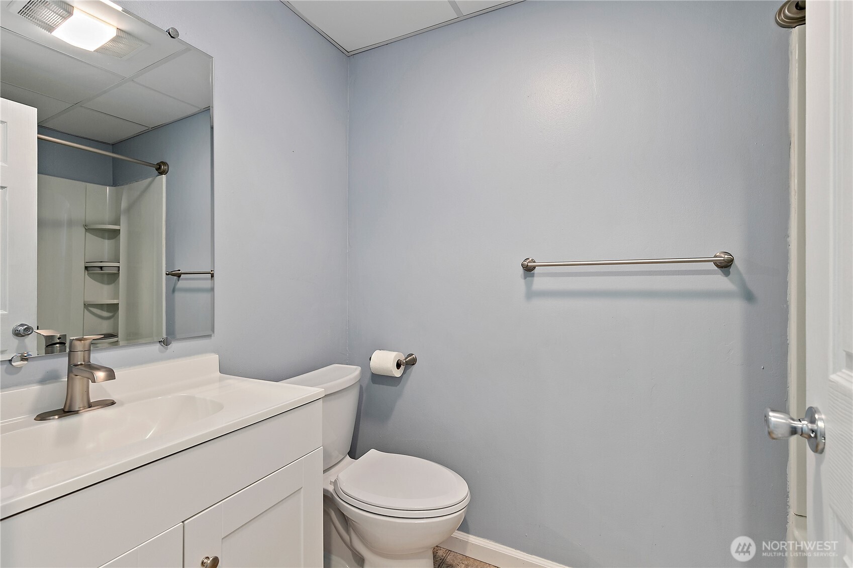 9880 Fredrickson Road Northwest Bremerton, WA 98311 - Photo 22 of 28 a bathroom with a granite countertop sink toilet and a mirror
