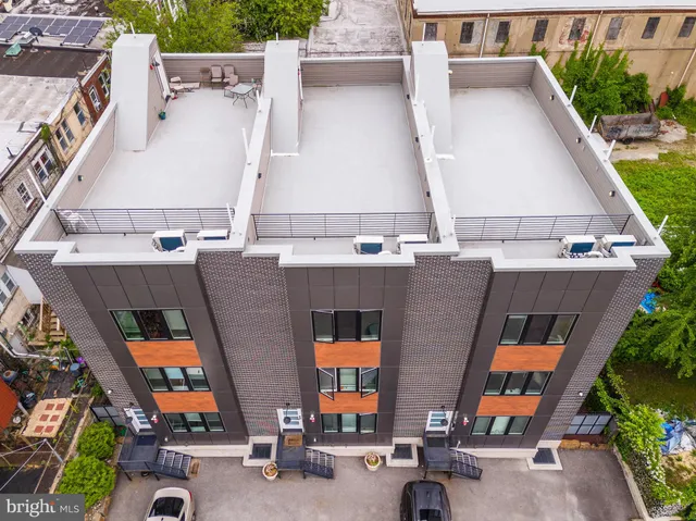 an aerial view of residential houses with outdoor space