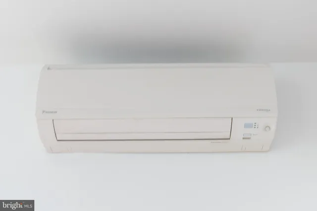 a kitchen with sink a microwave and cabinets