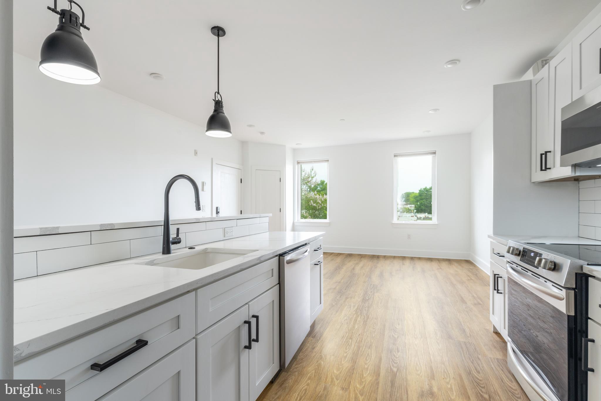 85 East Sharpnack Street Philadelphia, PA 19119 - Photo 34 of 47 a kitchen with sink a microwave and cabinets