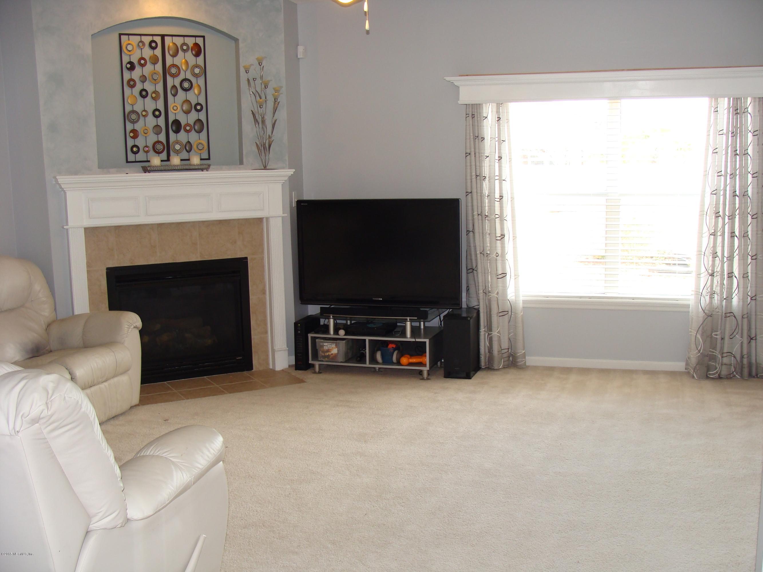 229 Porta Rosa Circle St. Augustine, FL 32092 - Photo 11 of 41 a living room with furniture and a flat screen tv