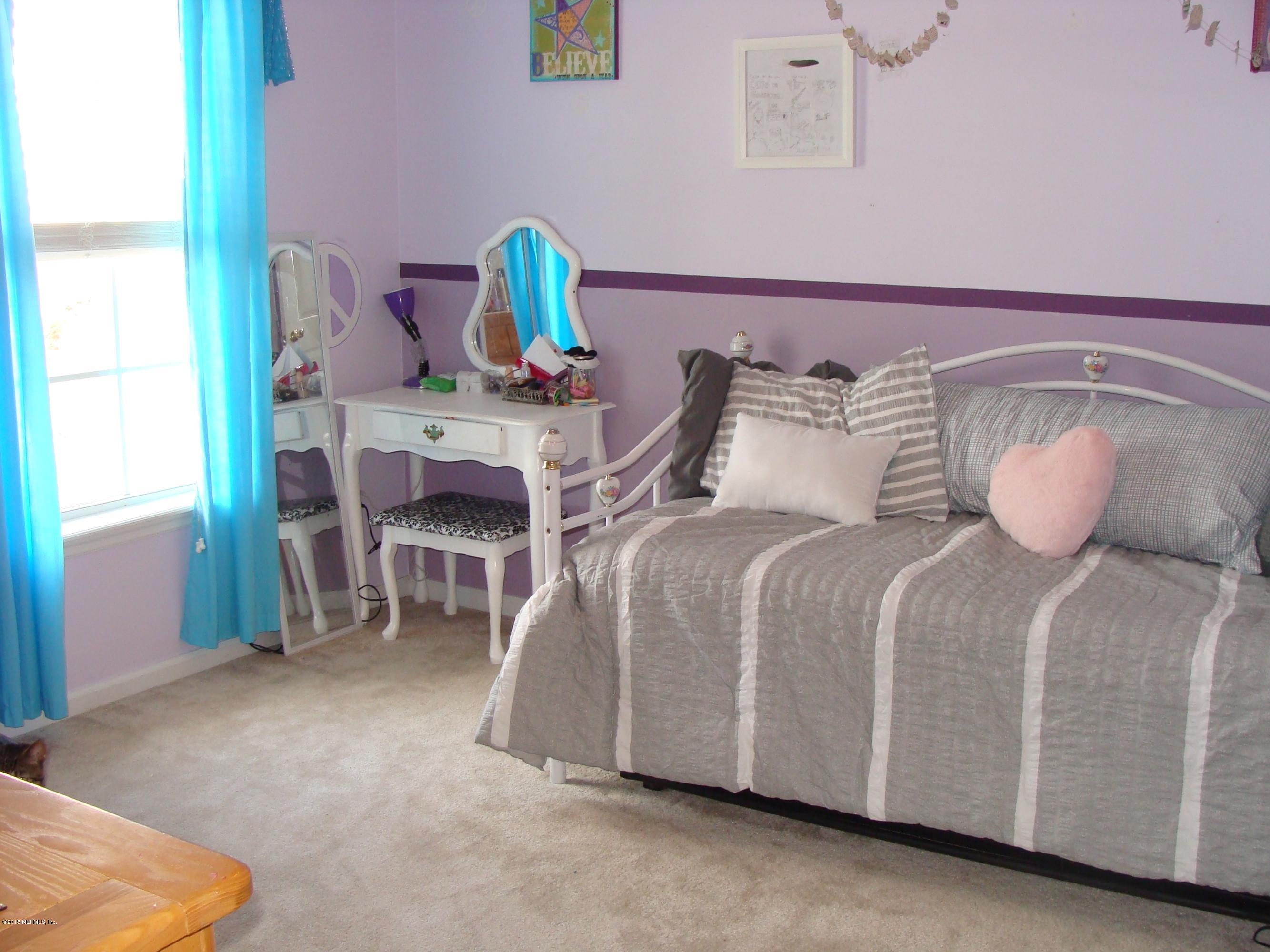 229 Porta Rosa Circle St. Augustine, FL 32092 - Photo 18 of 41 a bed room with a bed and a chair