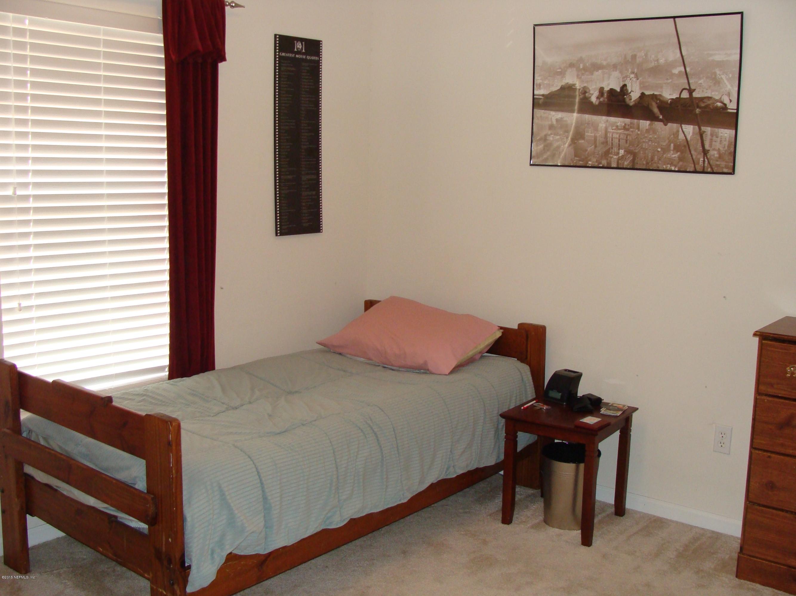 229 Porta Rosa Circle St. Augustine, FL 32092 - Photo 19 of 41 a bedroom with a bed and a painting on the wall