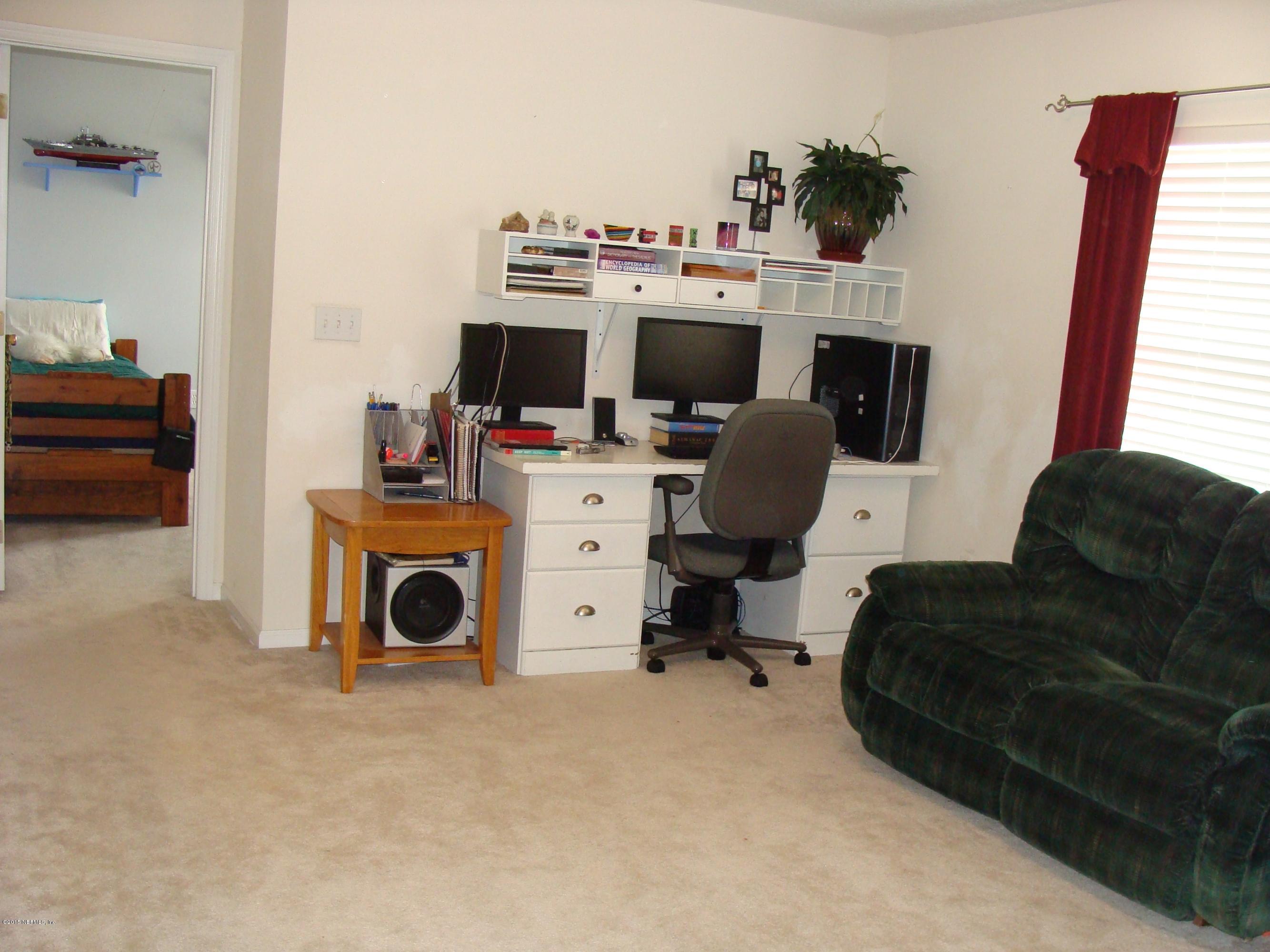 229 Porta Rosa Circle St. Augustine, FL 32092 - Photo 20 of 41 a living room with furniture a flat screen tv and a fireplace