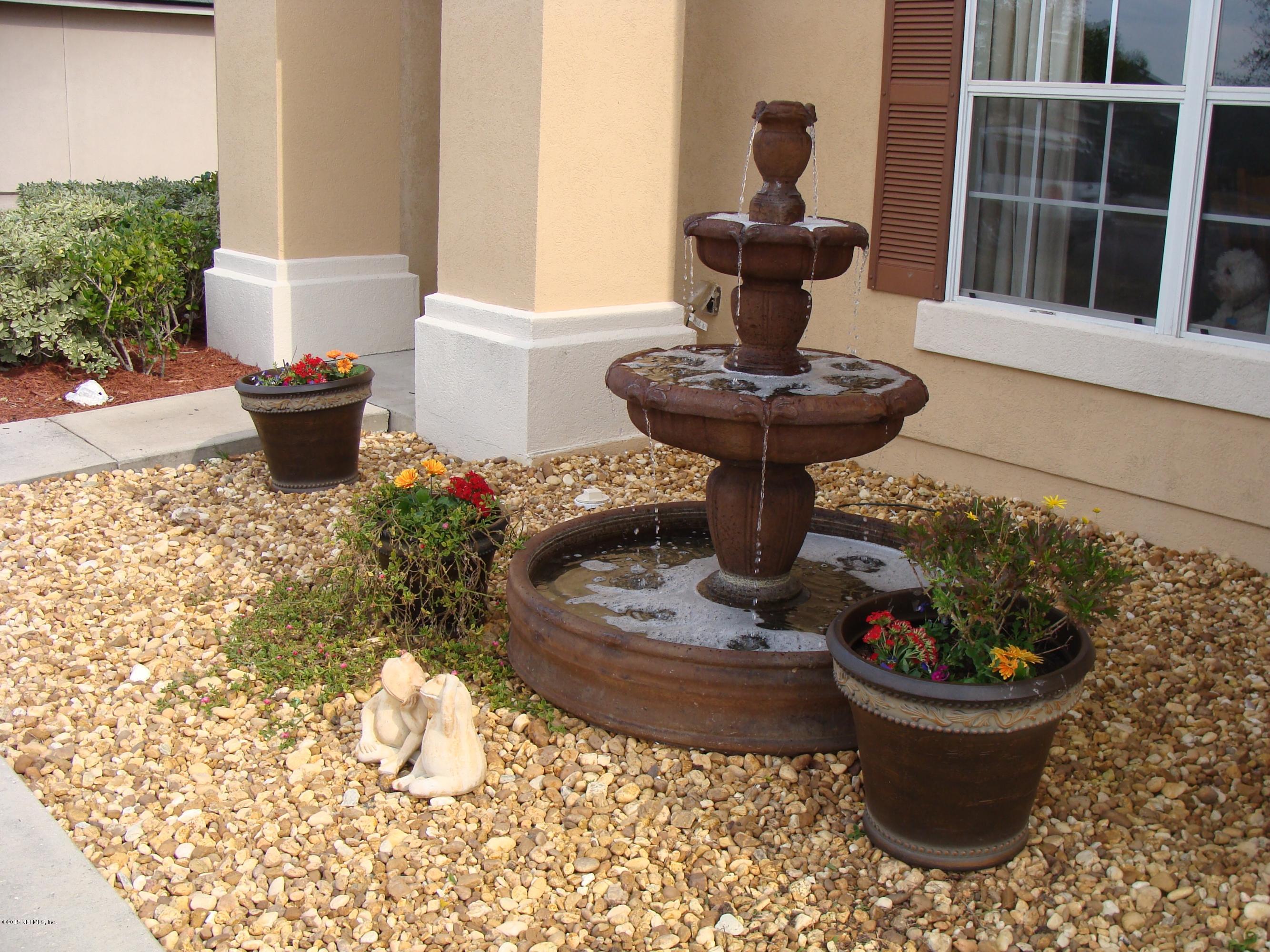 229 Porta Rosa Circle St. Augustine, FL 32092 - Photo 23 of 41 a view of a porch with a potted plant and a fountain