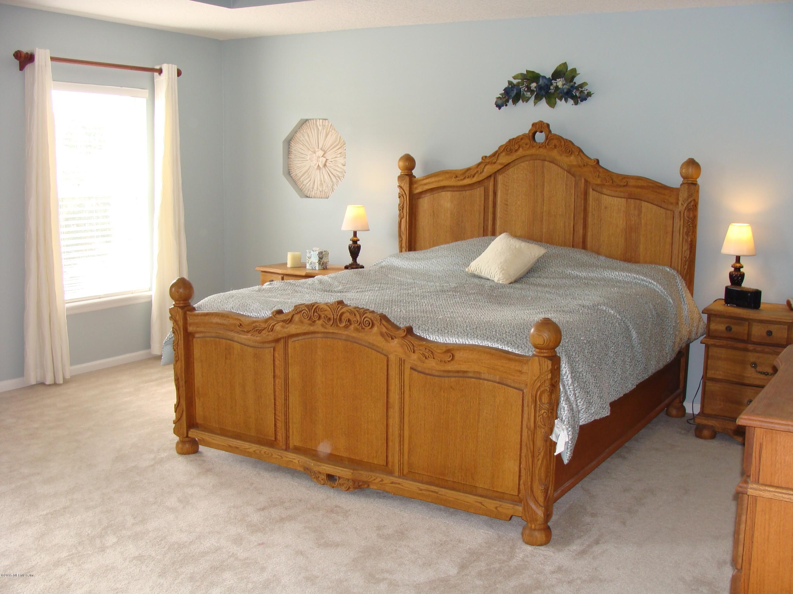 229 Porta Rosa Circle St. Augustine, FL 32092 - Photo 3 of 41 a bedroom with a bed and a chandelier