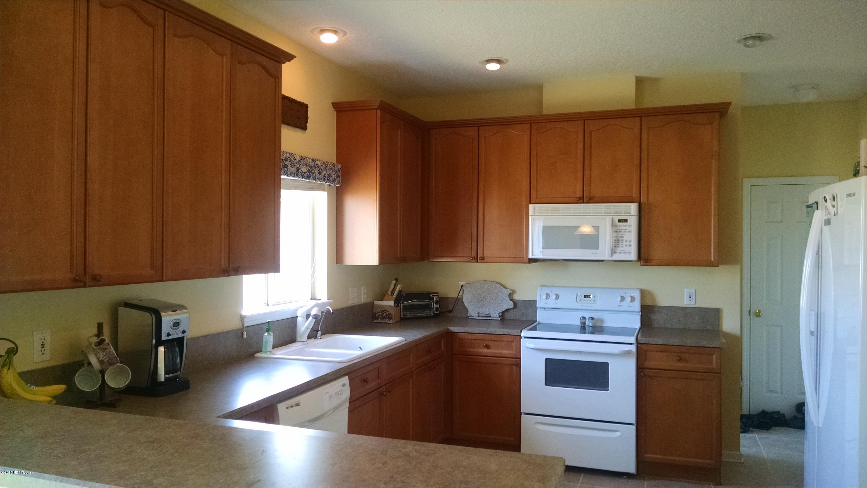 229 Porta Rosa Circle St. Augustine, FL 32092 - Photo 5 of 41 a kitchen with a refrigerator and a sink