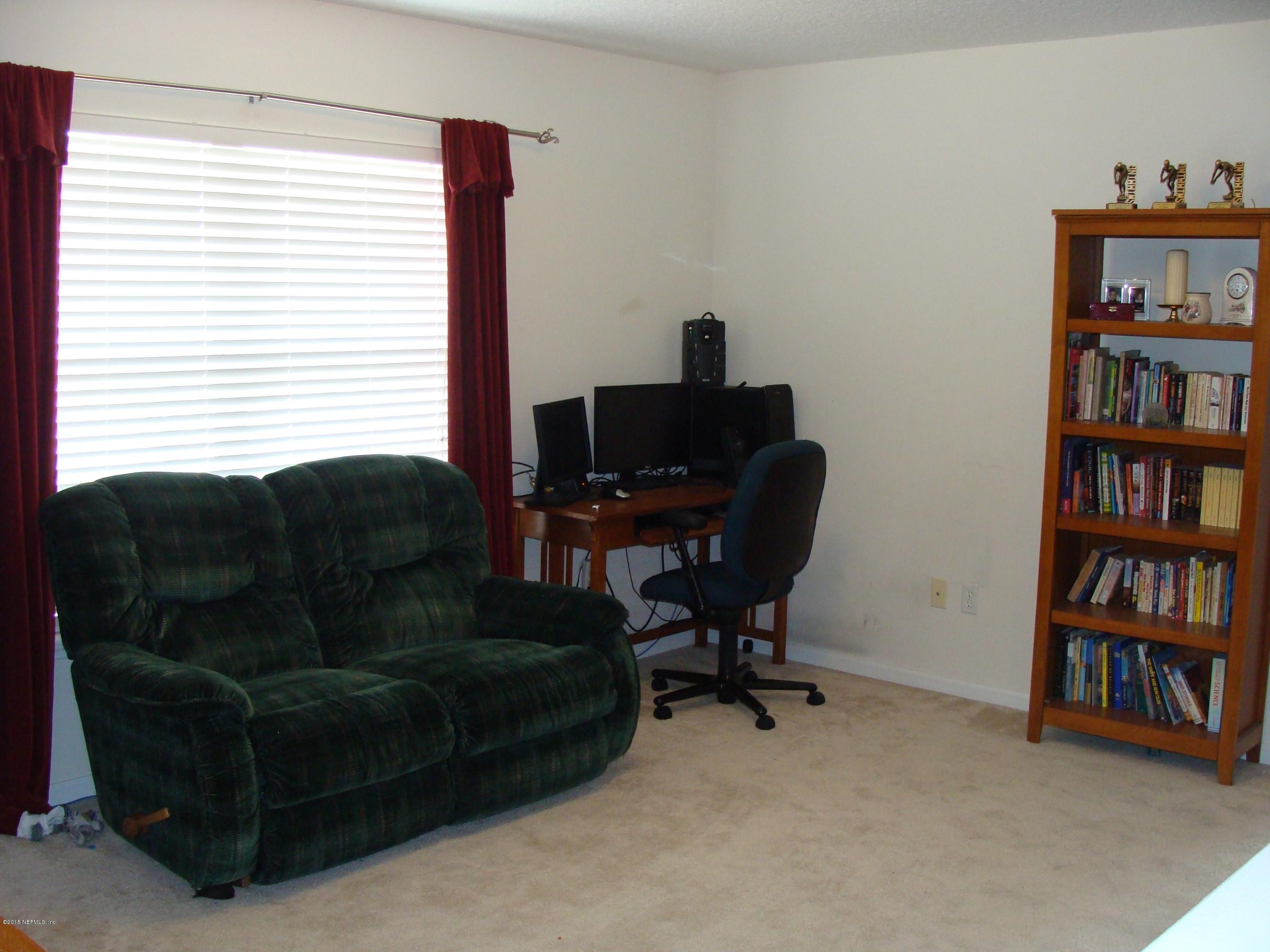 229 Porta Rosa Circle St. Augustine, FL 32092 - Photo 9 of 41 a living room with furniture and a book shelf