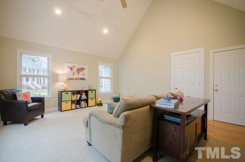 8321 Apple Orchard Way Raleigh, NC 27615 - Photo 12 of 24 a living room with furniture and a flat screen tv