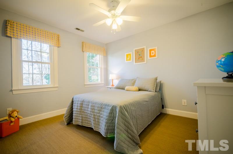 8321 Apple Orchard Way Raleigh, NC 27615 - Photo 17 of 24 a bedroom with a bed and a window