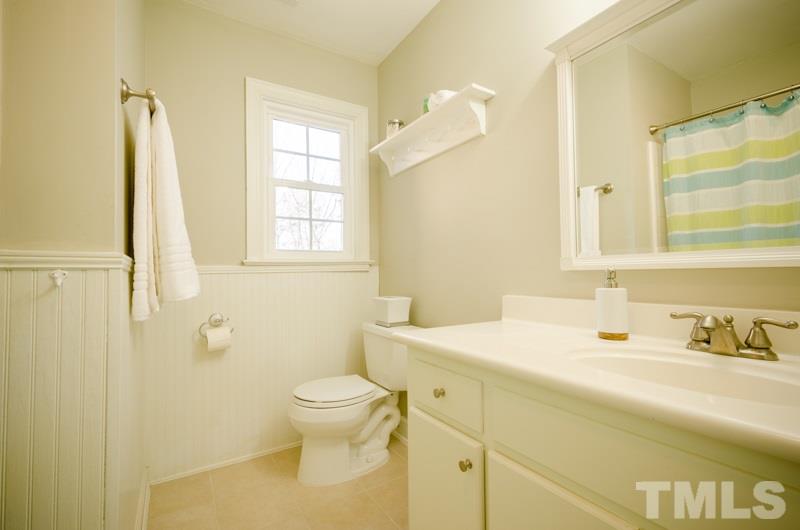 8321 Apple Orchard Way Raleigh, NC 27615 - Photo 18 of 24 a bathroom with a sink toilet and vanity