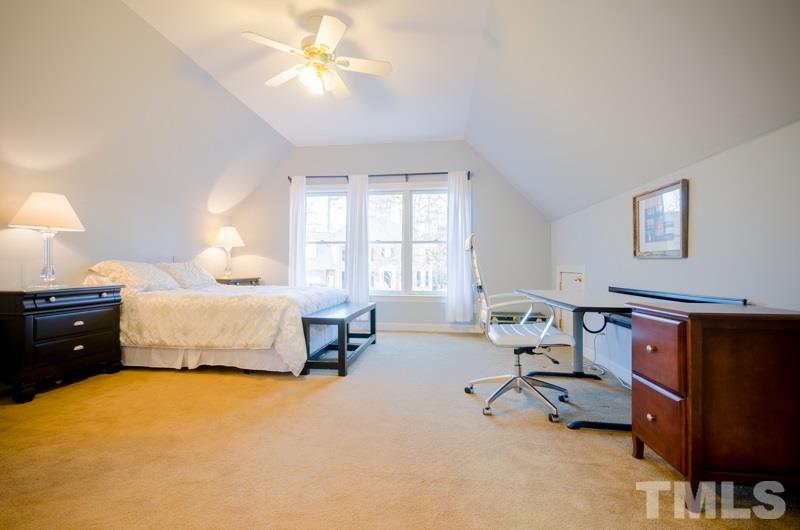 8321 Apple Orchard Way Raleigh, NC 27615 - Photo 19 of 24 a bedroom with a bed and a chandelier