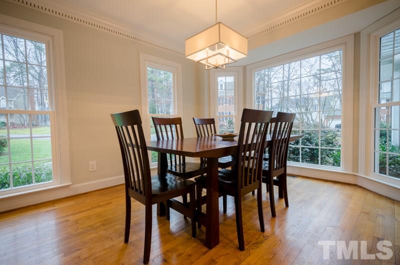 8321 Apple Orchard Way Raleigh, NC 27615 - Photo 5 of 24 a view of a dining room with furniture window and wooden floor