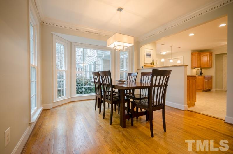 8321 Apple Orchard Way Raleigh, NC 27615 - Photo 6 of 24 a view of a dining room with furniture window and wooden floor