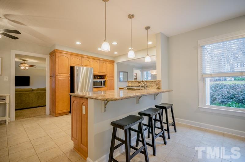 8321 Apple Orchard Way Raleigh, NC 27615 - Photo 8 of 24 a large kitchen with a table and chairs