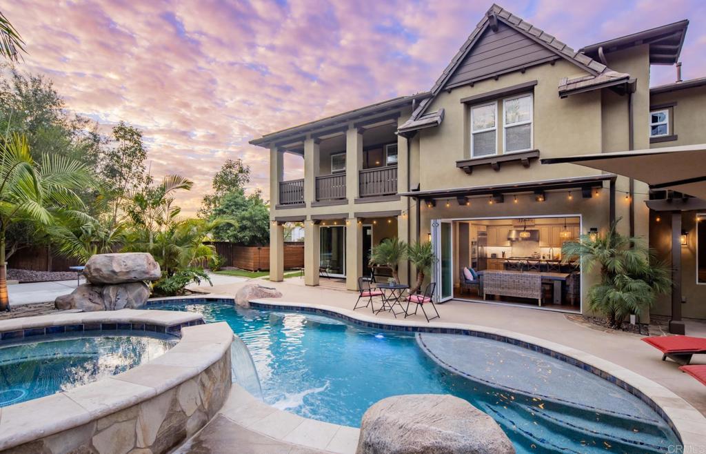 a view of a house with swimming pool and sitting area
