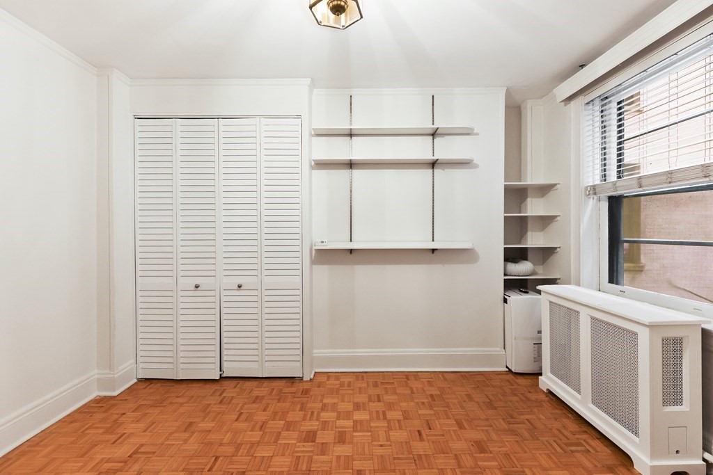 21 Beacon Street, Unit 5D Boston, MA 02108 - Photo 3 of 11 a view of empty room with wooden floor and windows