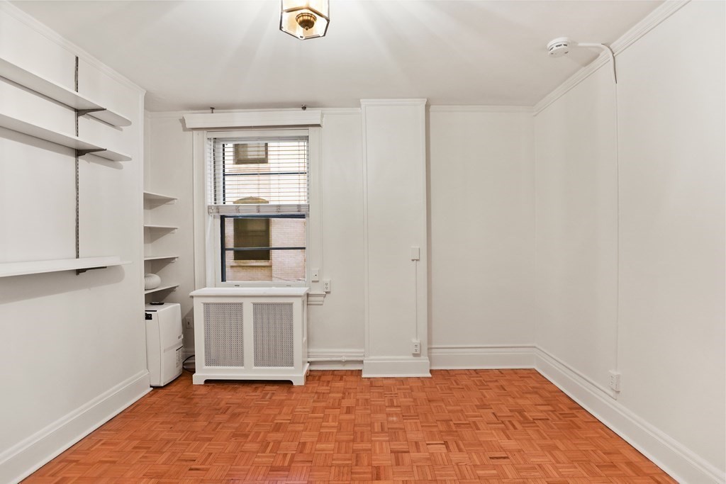 21 Beacon Street, Unit 5D Boston, MA 02108 - Photo 4 of 11 a view of an empty room with cabinet and windows