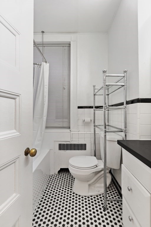 21 Beacon Street, Unit 5D Boston, MA 02108 - Photo 8 of 11 a bathroom with a sink toilet a shower and a mirror