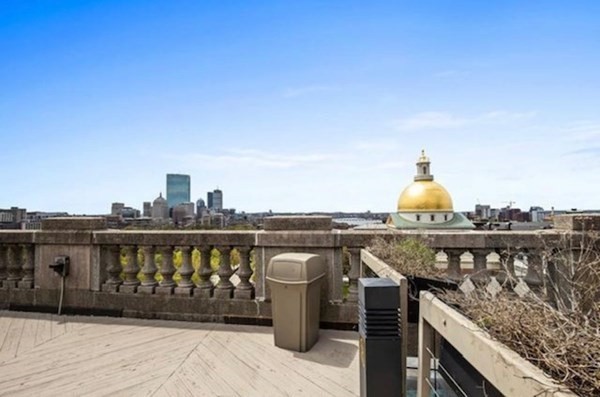 21 Beacon Street, Unit 5D Boston, MA 02108 - Photo 10 of 11 a view of a roof deck with wooden floor and barbeque oven