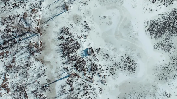 a view of a town with snow on the road