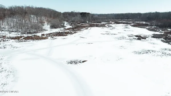 a view of a yard with wooden fence
