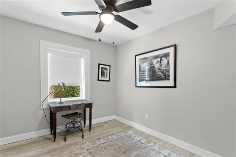 a view of a workspace with furniture and a window