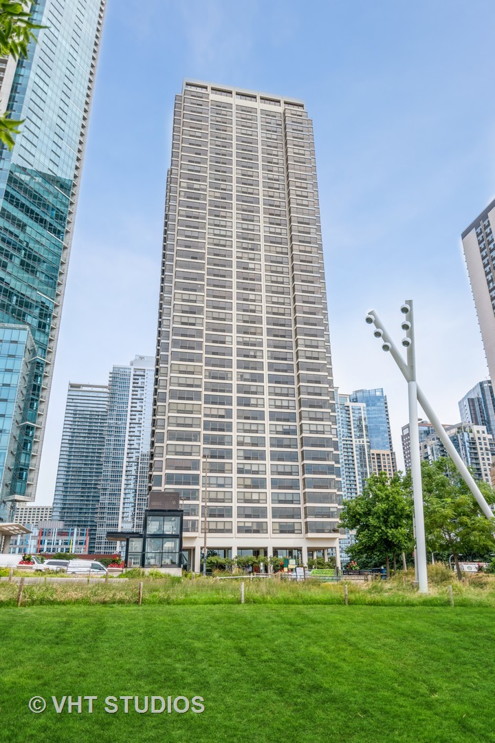 360 East Randolph Street, Unit 308 Chicago, IL 60601 - Photo 1 of 24 a front view of a building with a yard
