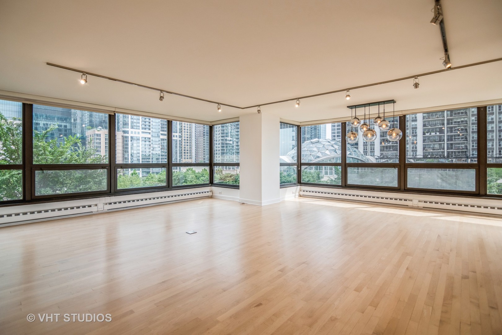 360 East Randolph Street, Unit 308 Chicago, IL 60601 - Photo 3 of 24 a view of an empty room with wooden floor and a window