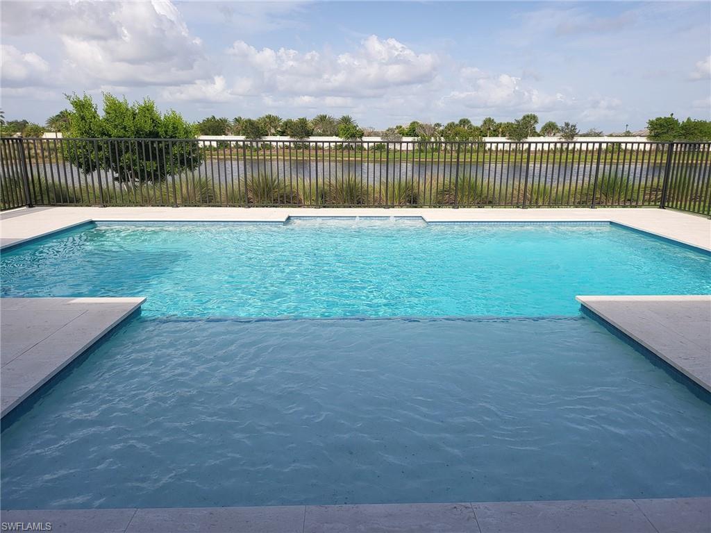 8770 Calypso Court Naples, FL 34113 - Photo 12 of 47 a swimming pool with lake view