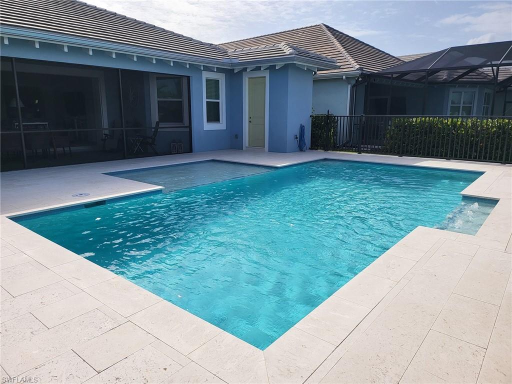 8770 Calypso Court Naples, FL 34113 - Photo 13 of 47 a view of a house with a yard