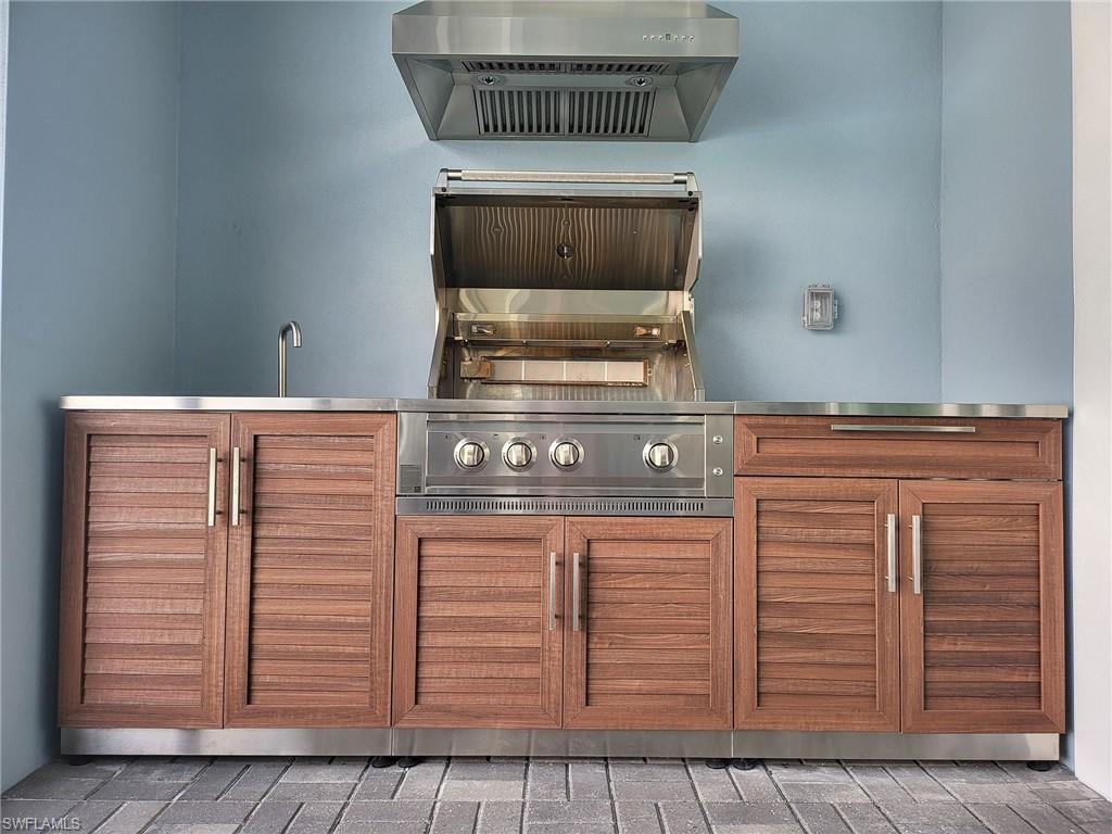 8770 Calypso Court Naples, FL 34113 - Photo 16 of 47 a stove top oven sitting inside of a kitchen