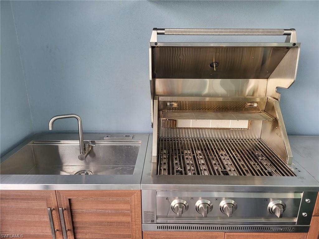 8770 Calypso Court Naples, FL 34113 - Photo 17 of 47 a close view of a sink and a microwave