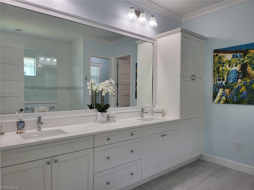 8770 Calypso Court Naples, FL 34113 - Photo 23 of 47 a bathroom with a double vanity sink and a mirror
