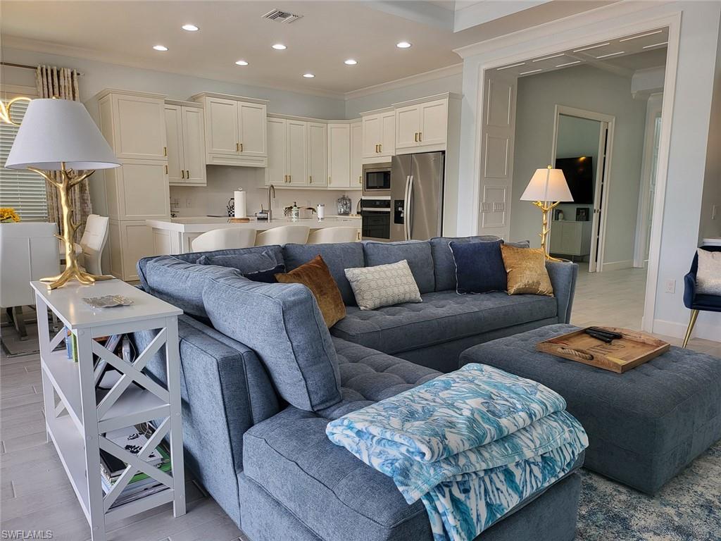 8770 Calypso Court Naples, FL 34113 - Photo 27 of 47 a living room with furniture and a table
