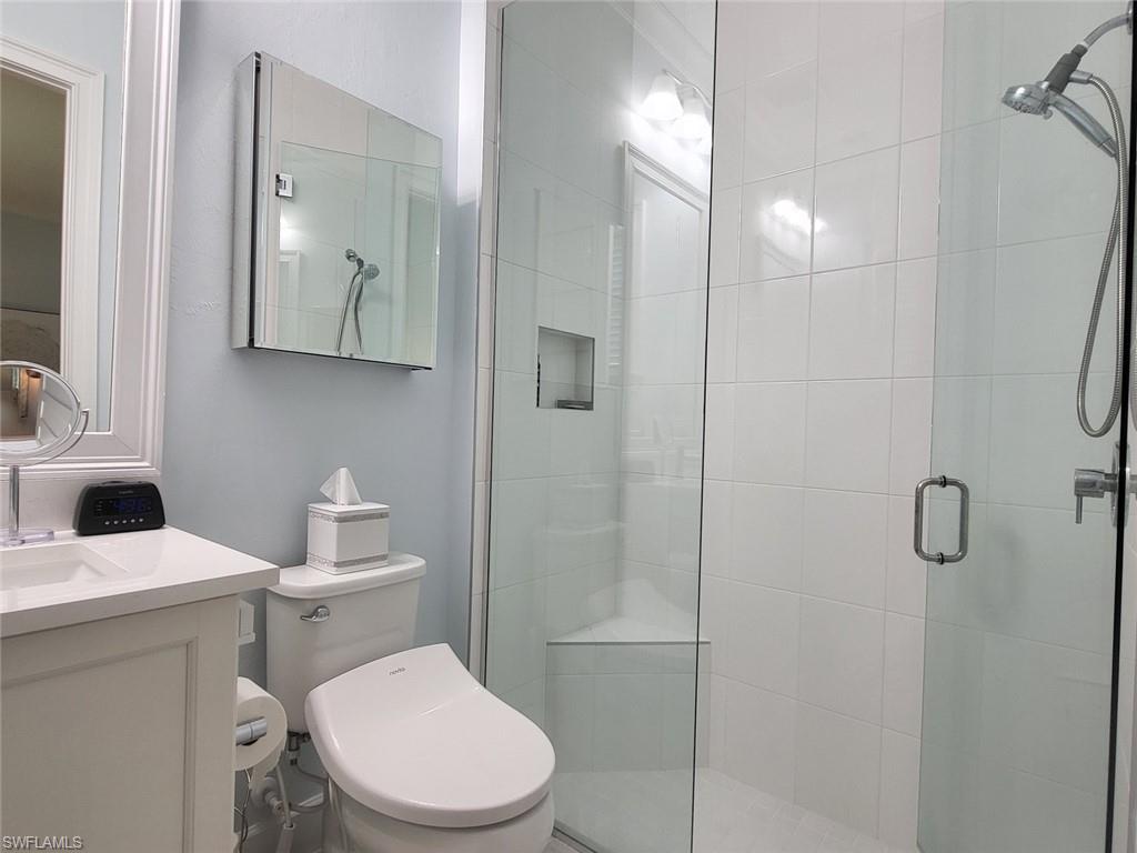 8770 Calypso Court Naples, FL 34113 - Photo 29 of 47 a white toilet sitting next to a bathroom sink
